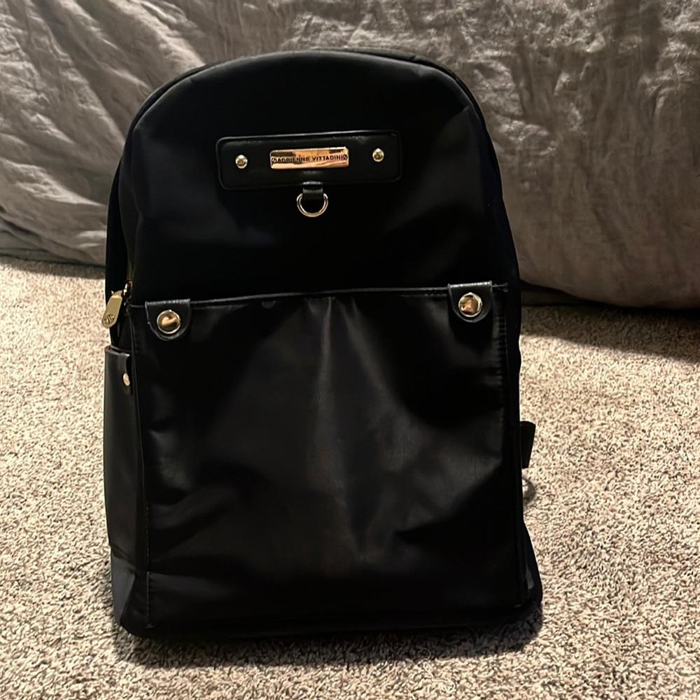 Black backpack with gold accents.